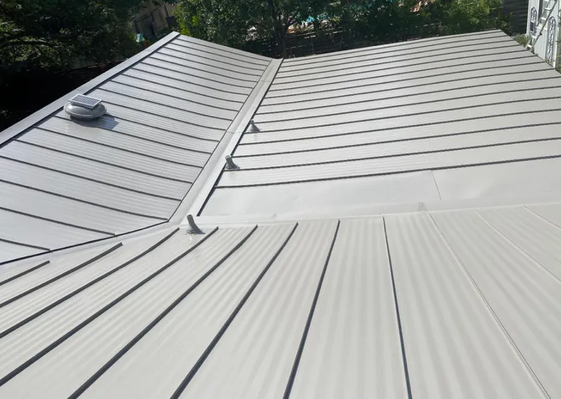 Solar attic fan installed on a metal roof for Roof Ventilation in Crosspointe
